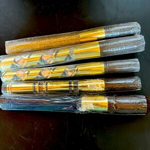 Various brands of makeup brushes.  1 Estes Lauder and 4 unknown.